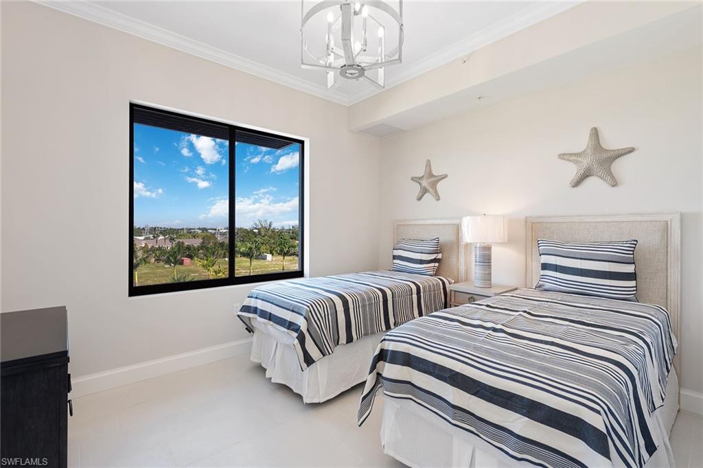 1111 Central Avenue, Unit 506 Naples, FL 34102 - Photo 12 of 21 a bedroom with two large bed and a window