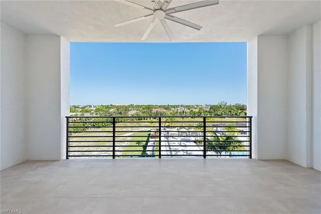 a view of a room with stairs and a ceiling fan
