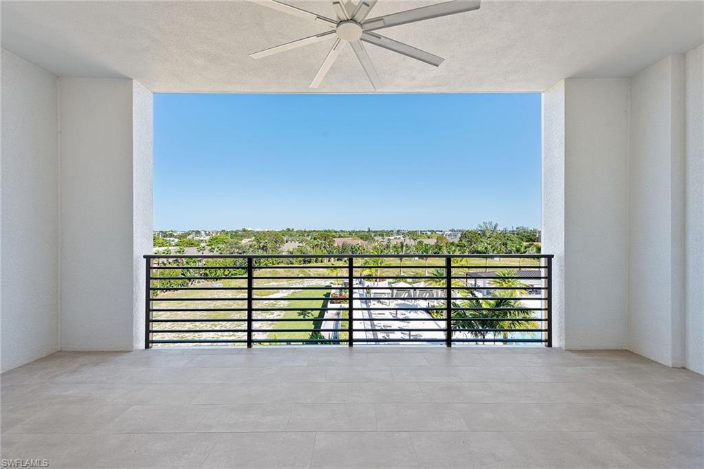 1111 Central Avenue, Unit 506 Naples, FL 34102 - Photo 17 of 21 a view of a room with stairs and a ceiling fan