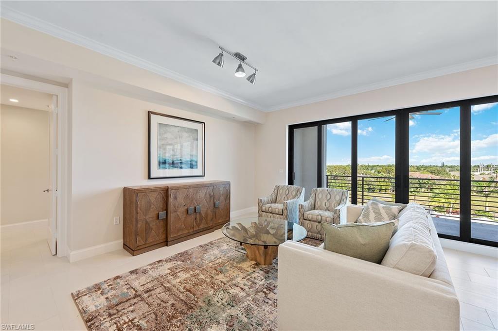 1111 Central Avenue, Unit 506 Naples, FL 34102 - Photo 2 of 21 a living room with furniture and large windows