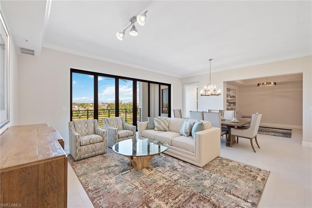 1111 Central Avenue, Unit 506 Naples, FL 34102 - Photo 4 of 21 a living room with furniture wooden floor and a table