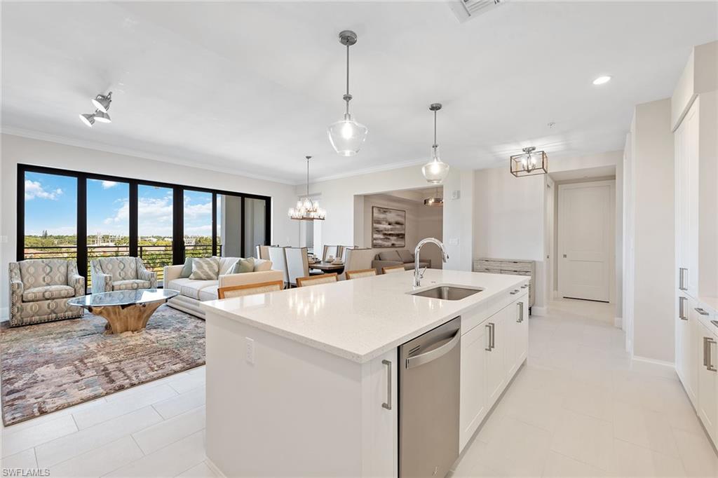 1111 Central Avenue, Unit 506 Naples, FL 34102 - Photo 8 of 21 a large kitchen with kitchen island a large island in it