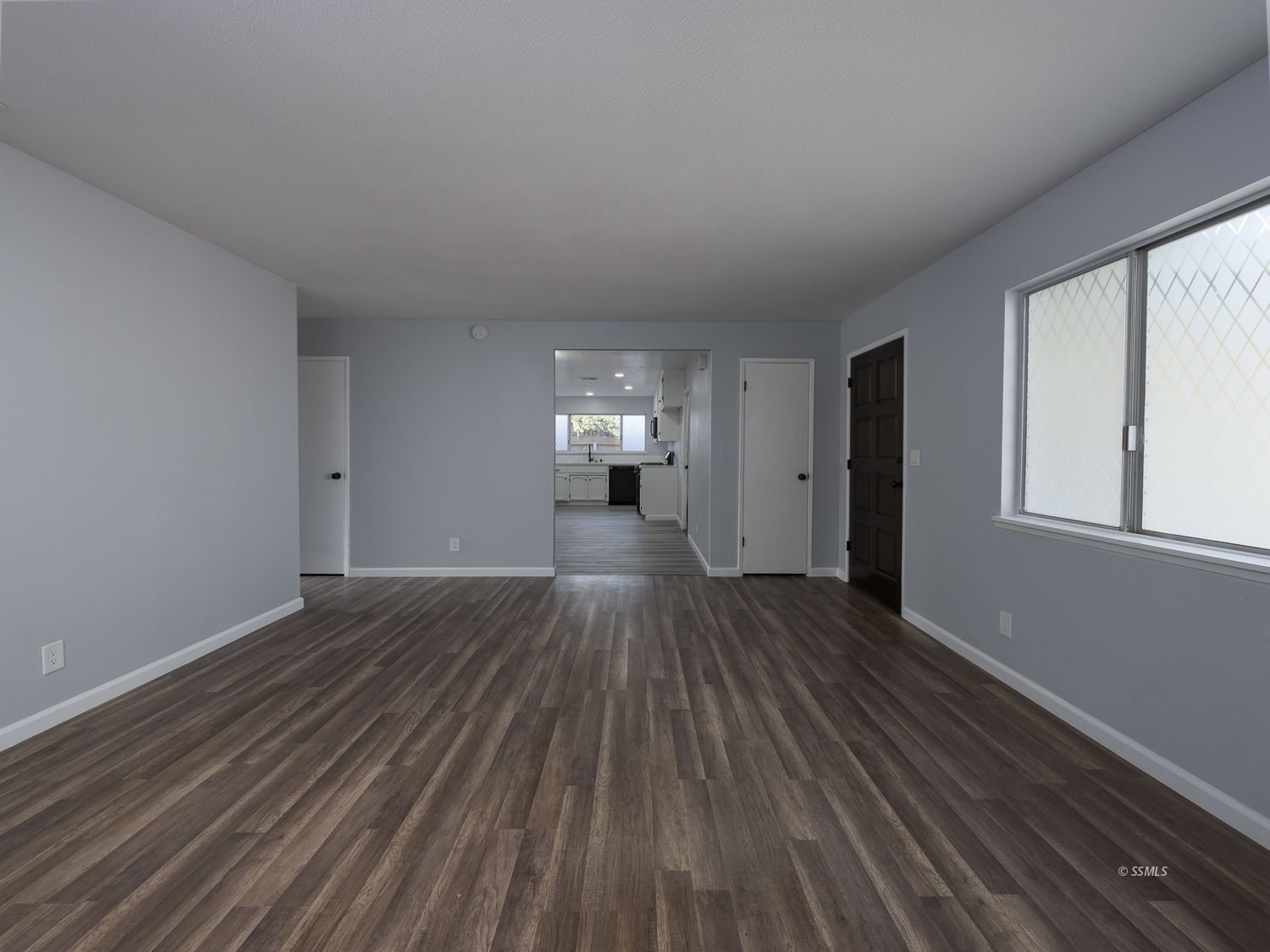 413 South Lincoln Street Ridgecrest, CA 93555 - Photo 10 of 34 wooden floor in an empty room with a window