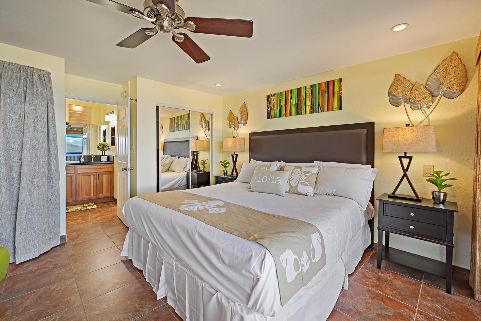 4909 Lower Honoapiilani Road, Unit E5 Lahaina, HI 96761 - Photo 11 of 28 a bedroom with a bed and wooden floor