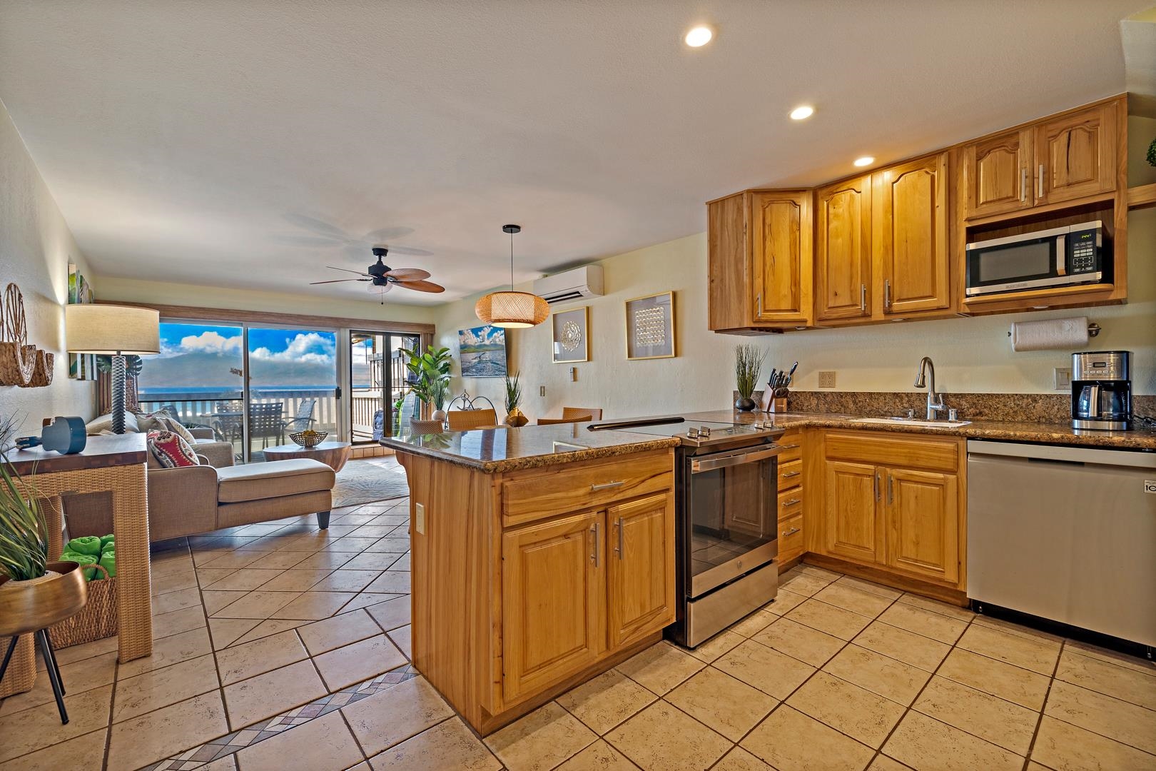 4909 Lower Honoapiilani Road, Unit E5 Lahaina, HI 96761 - Photo 15 of 28 a kitchen with stainless steel appliances granite countertop a sink and cabinets