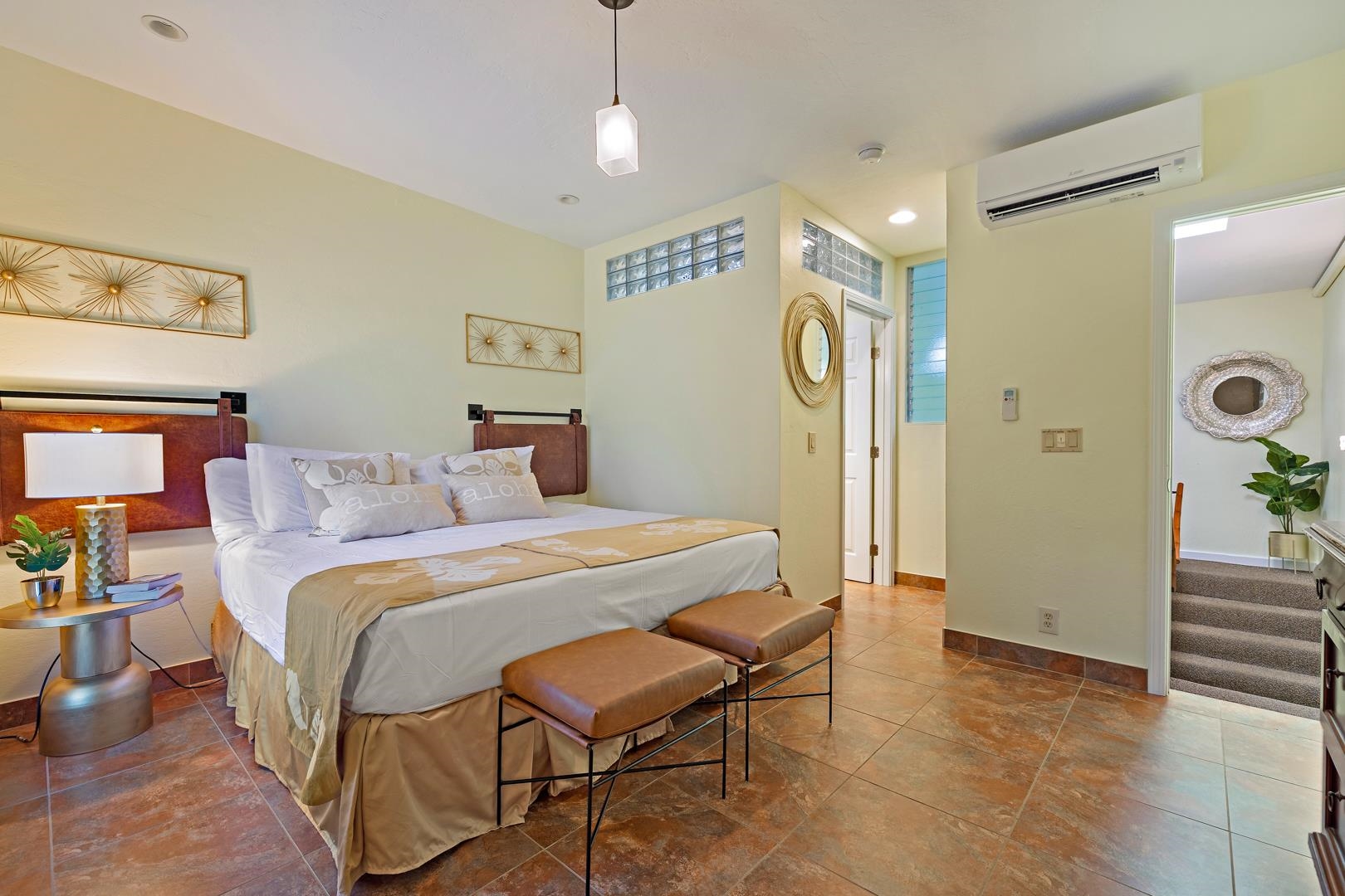 4909 Lower Honoapiilani Road, Unit E5 Lahaina, HI 96761 - Photo 21 of 28 a bedroom with a bed and a table