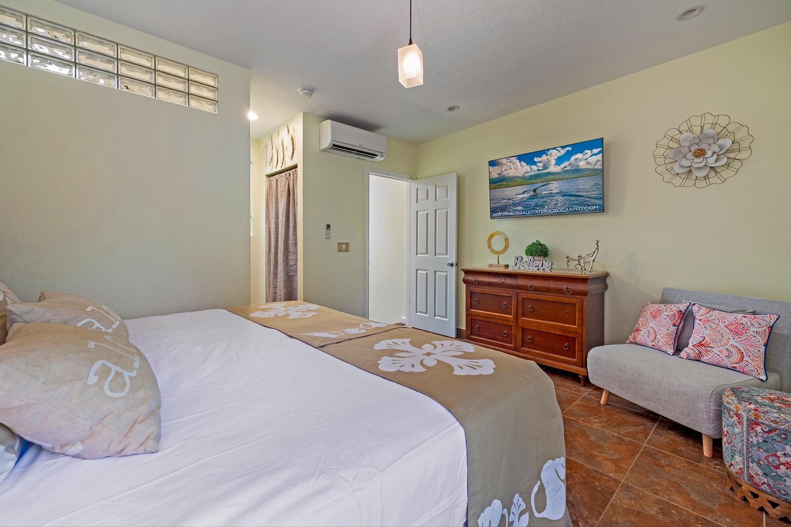 4909 Lower Honoapiilani Road, Unit E5 Lahaina, HI 96761 - Photo 22 of 28 a bed room with a bed and a couch