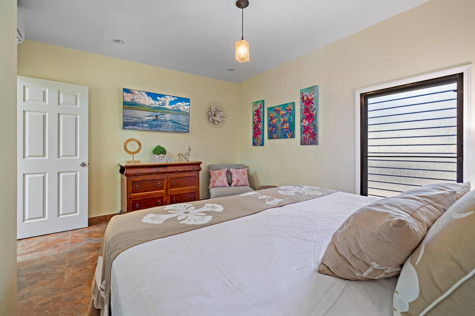 4909 Lower Honoapiilani Road, Unit E5 Lahaina, HI 96761 - Photo 23 of 28 a bedroom with a bed dresser and a window