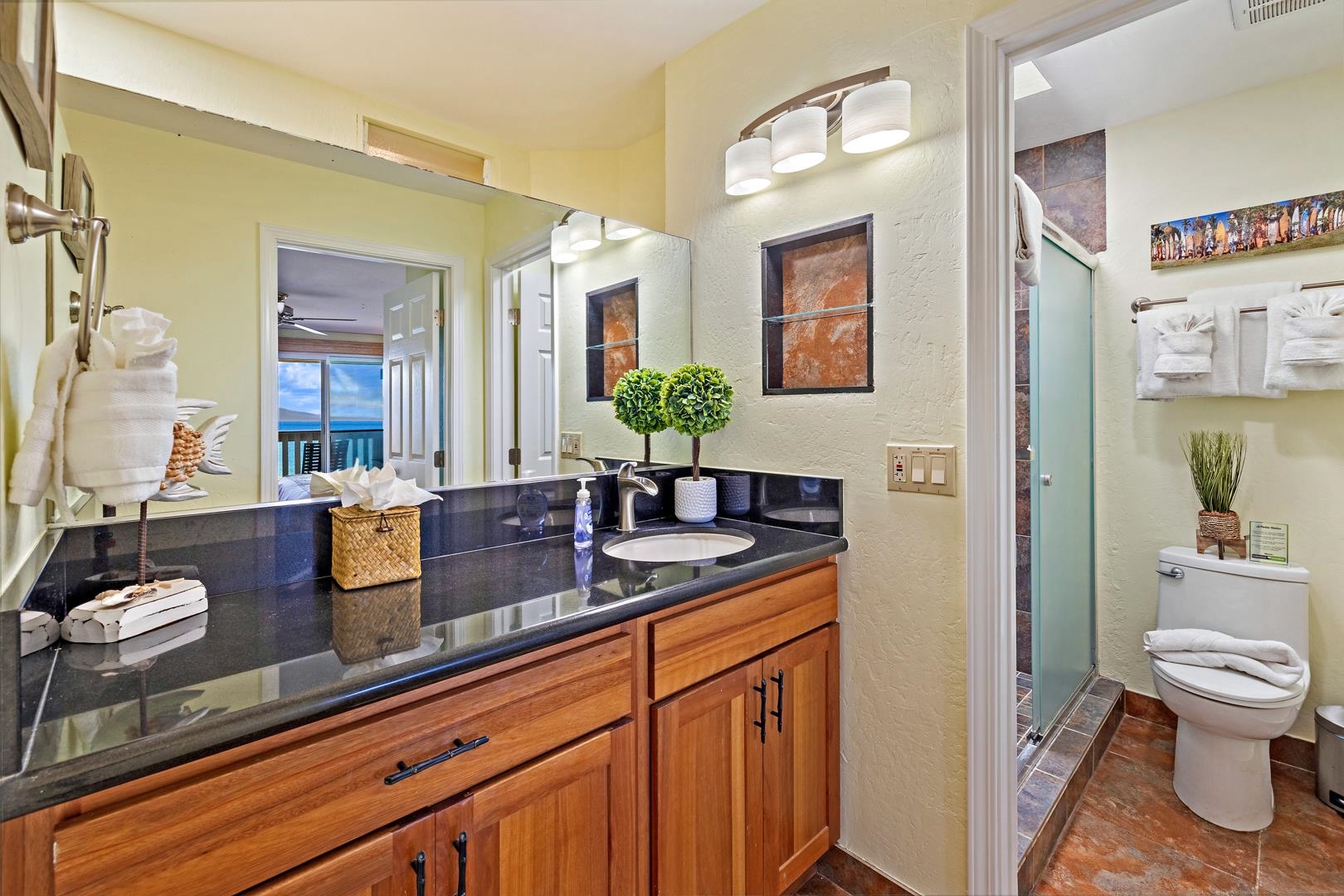 4909 Lower Honoapiilani Road, Unit E5 Lahaina, HI 96761 - Photo 24 of 28 a bathroom with a granite countertop sink mirror and toilet
