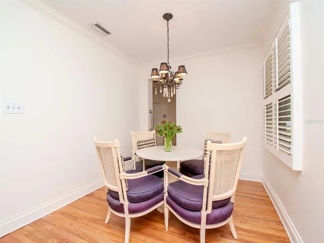 a dining room with furniture and wooden floor