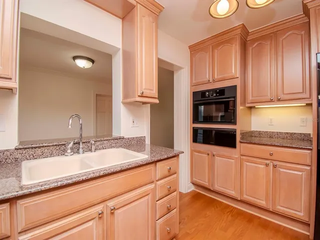 a kitchen with stainless steel appliances granite countertop a sink and cabinets