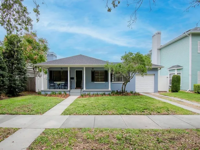 a front view of a house with a garden and yard