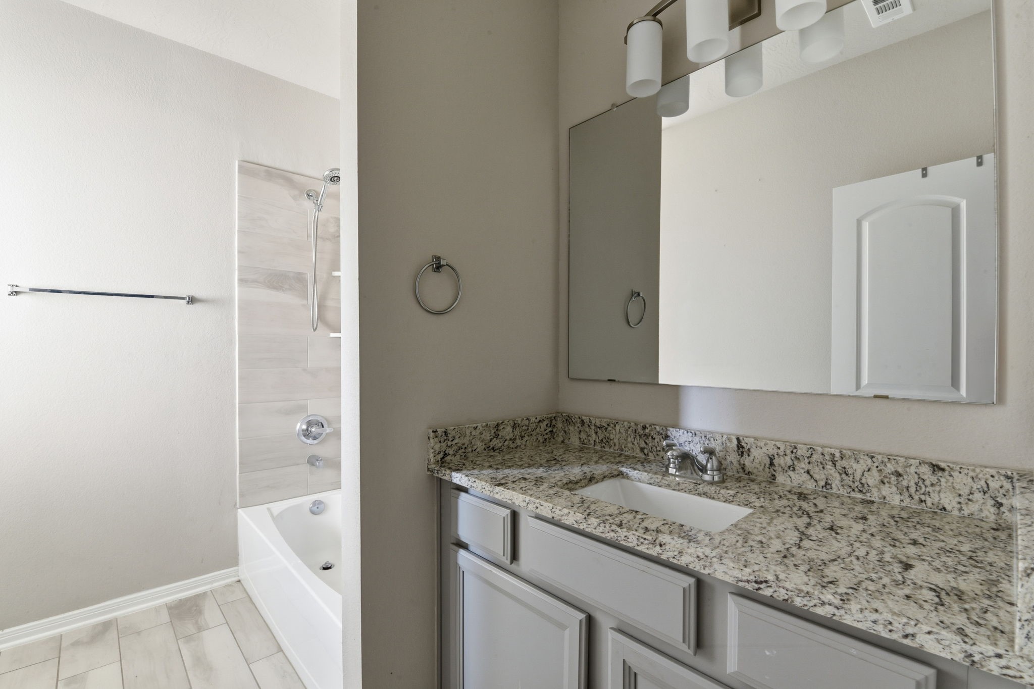 115 Austin Street Angleton, TX 77515 - Photo 21 of 33 a bathroom with a granite countertop sink and a mirror