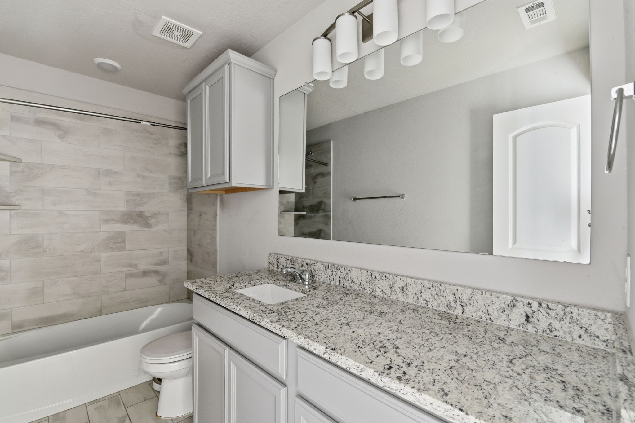 115 Austin Street Angleton, TX 77515 - Photo 25 of 33 a bathroom with a granite countertop sink a toilet and shower