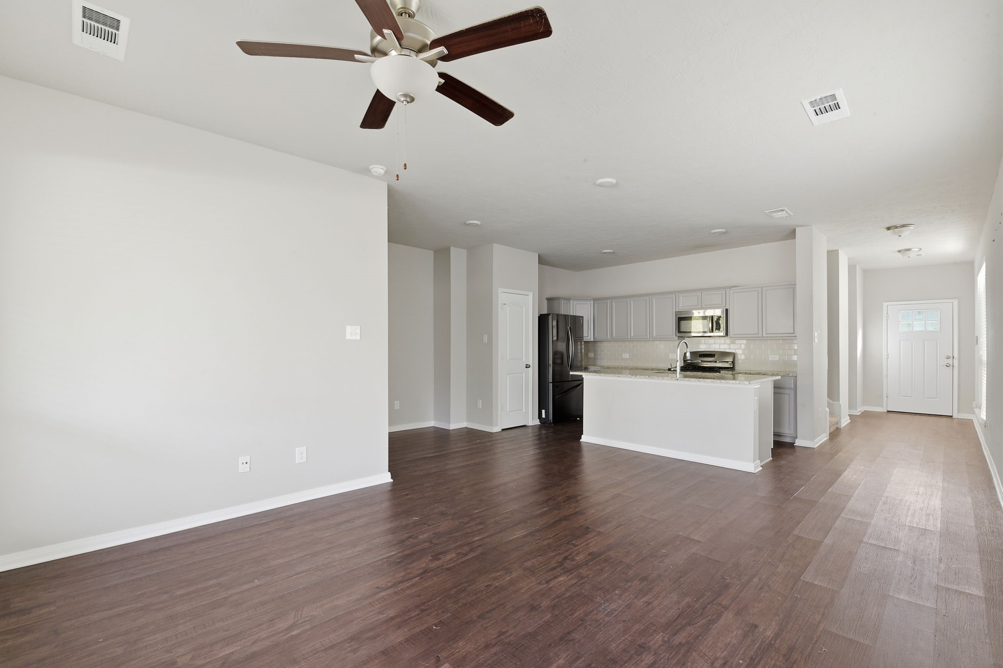 115 Austin Street Angleton, TX 77515 - Photo 6 of 33 a view of kitchen with refrigerator microwave and stove