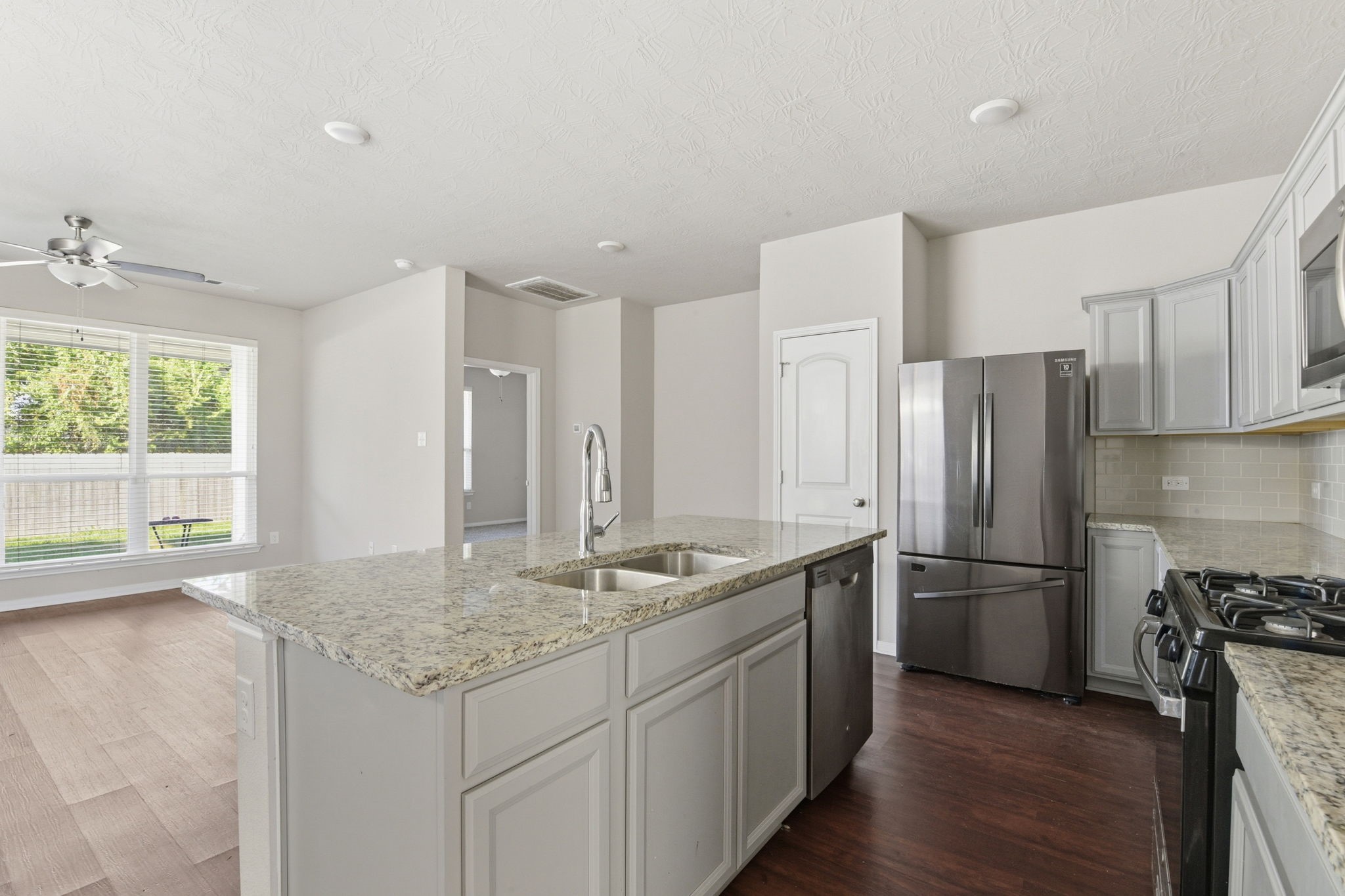 115 Austin Street Angleton, TX 77515 - Photo 8 of 33 a kitchen with stainless steel appliances granite countertop a refrigerator a sink and a stove