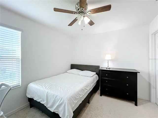 a bedroom with a bed and a table