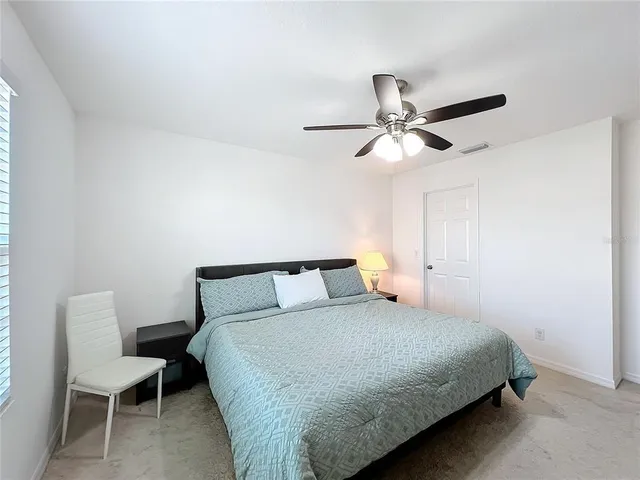 a bedroom with a large bed and a chandelier