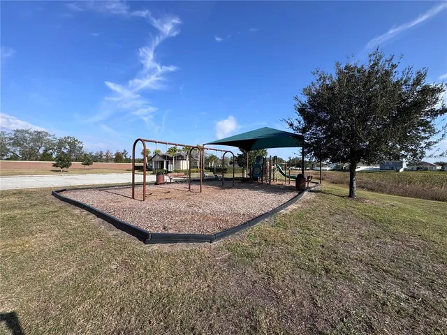 a view of a street with a building and a street sign