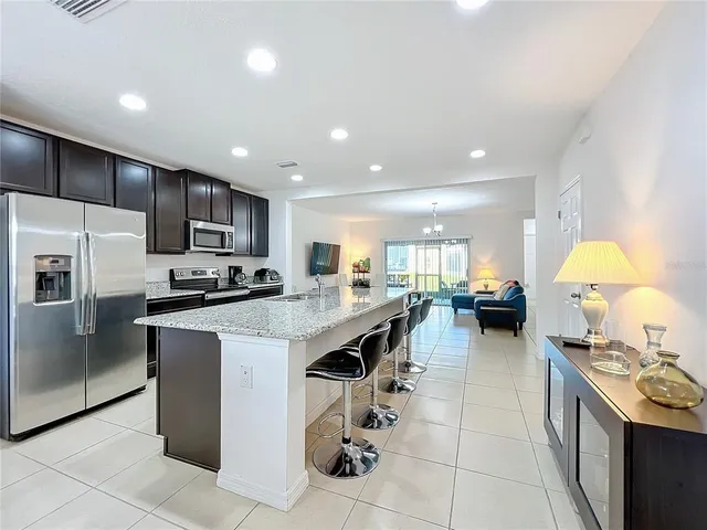 a kitchen with stainless steel appliances granite countertop a sink and stove