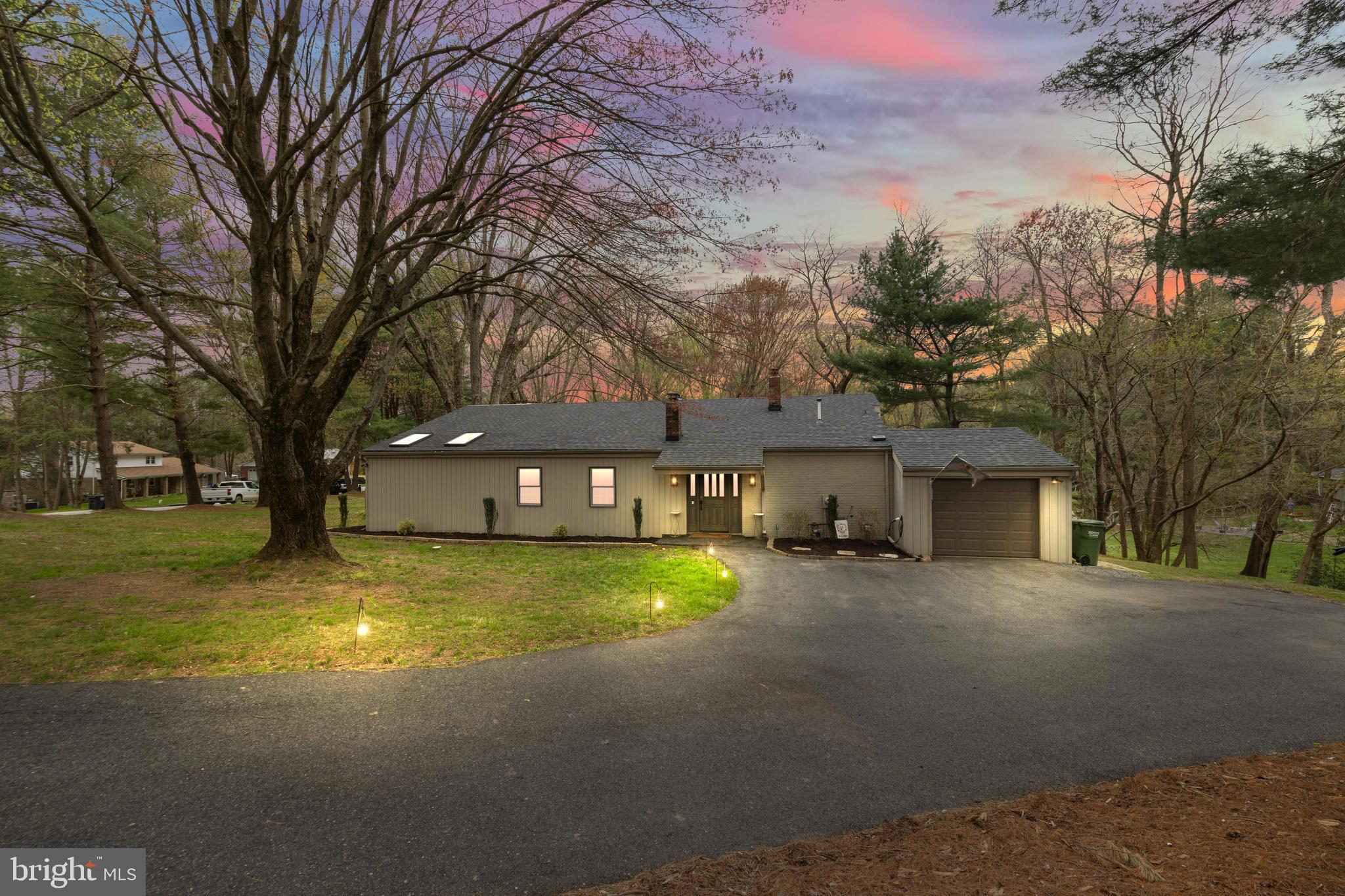 a view of a house with a large tree