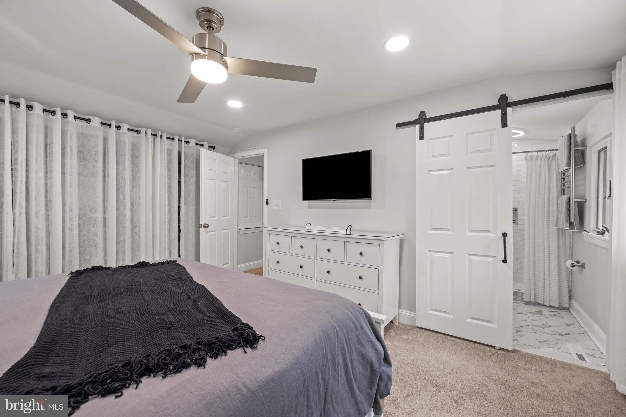 2414 Derby Drive Fallston, MD 21047 - Photo 24 of 41 a large bedroom with a bed and a flat tv screen on dresser