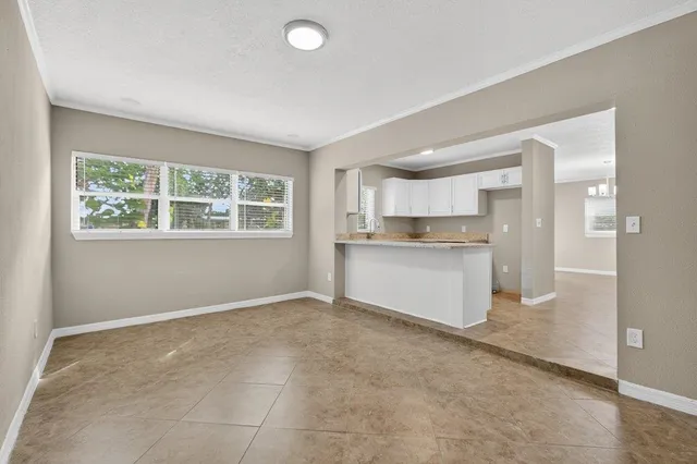 a view of a kitchen with wooden floor and a kitchen