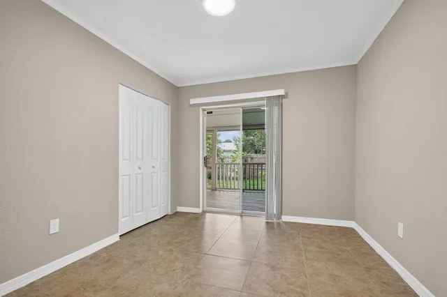 a view of an empty room with glass door