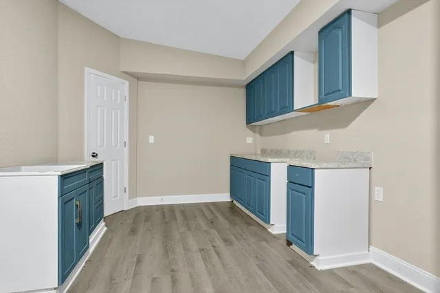 a kitchen with granite countertop wooden cabinets