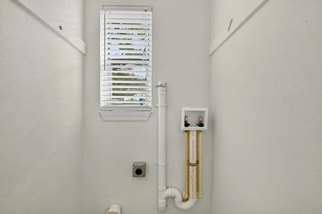 a bathroom with a shower and a window