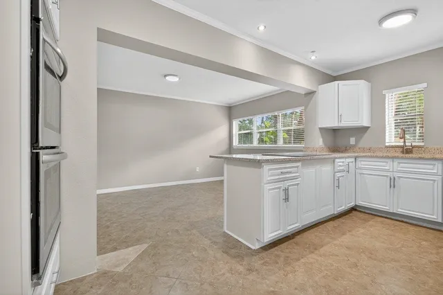 a kitchen with white cabinets and white appliances