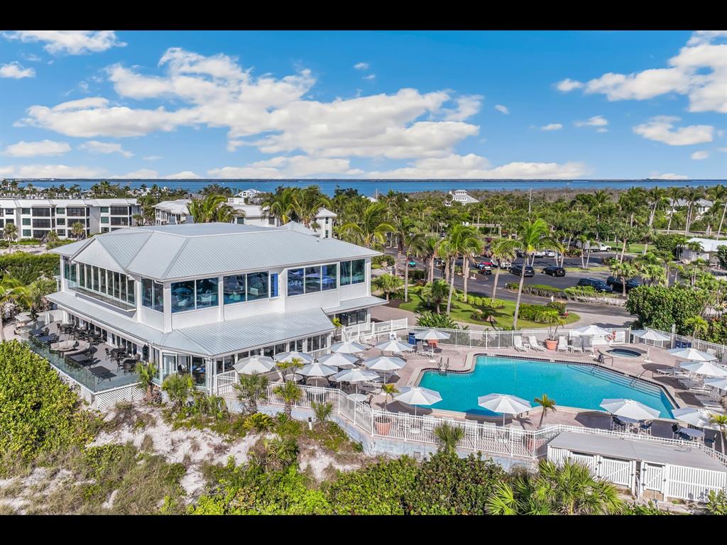 5000 Gasparilla Road, Unit BC201 Boca Grande, FL 33921 - Photo 18 of 25 a view of a house with a big yard with plants and large trees