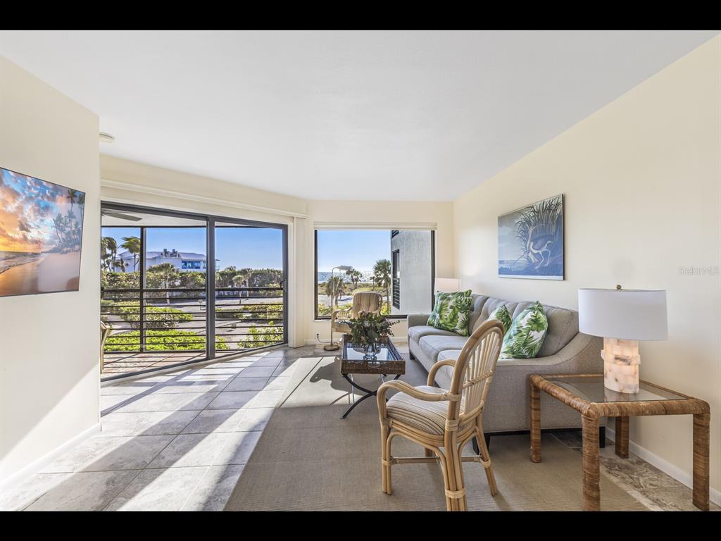 5000 Gasparilla Road, Unit BC201 Boca Grande, FL 33921 - Photo 2 of 25 a living room with fireplace furniture and a large window