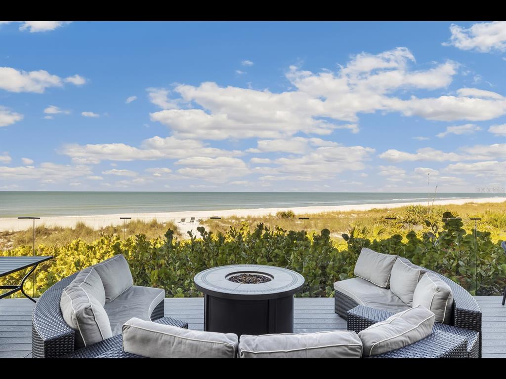 5000 Gasparilla Road, Unit BC201 Boca Grande, FL 33921 - Photo 25 of 25 a view of a patio with couches and table and chairs and potted plants