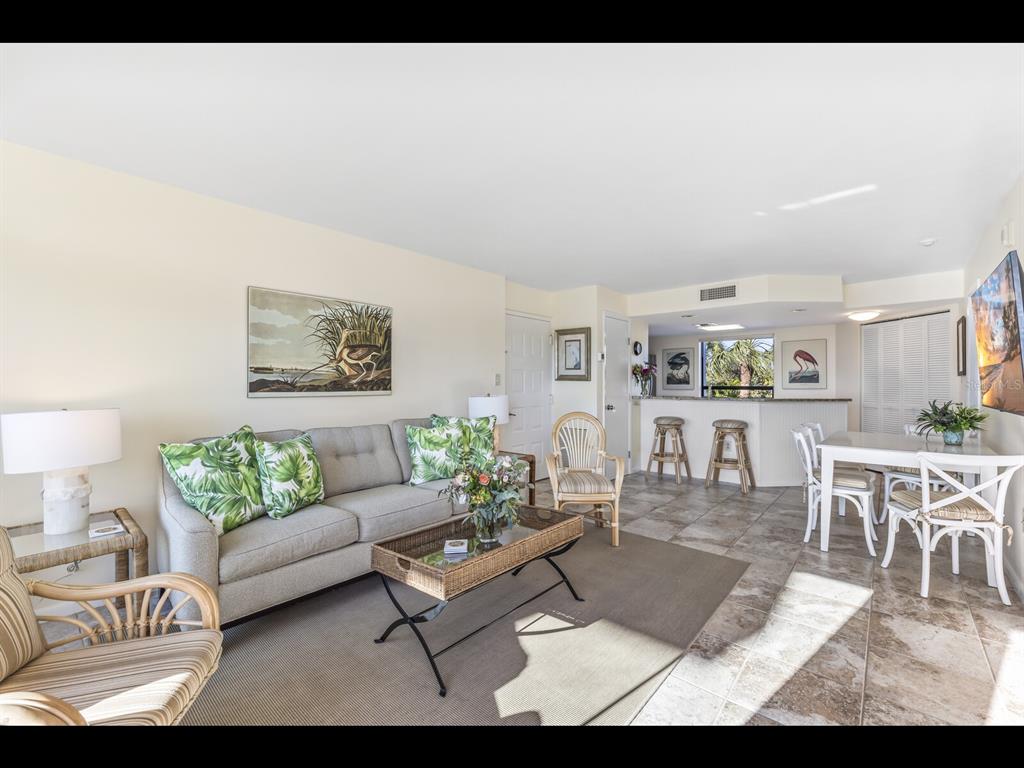 5000 Gasparilla Road, Unit BC201 Boca Grande, FL 33921 - Photo 3 of 25 a living room with furniture and a wooden floor