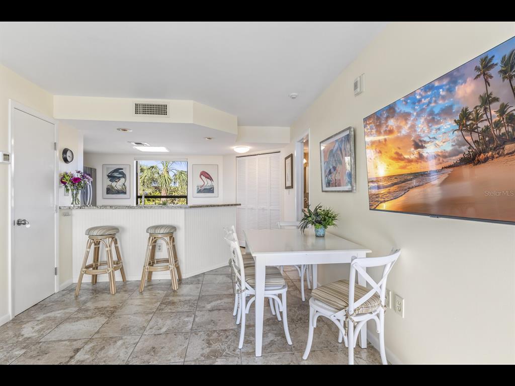 5000 Gasparilla Road, Unit BC201 Boca Grande, FL 33921 - Photo 6 of 25 a view of a dining room with furniture and wooden floor