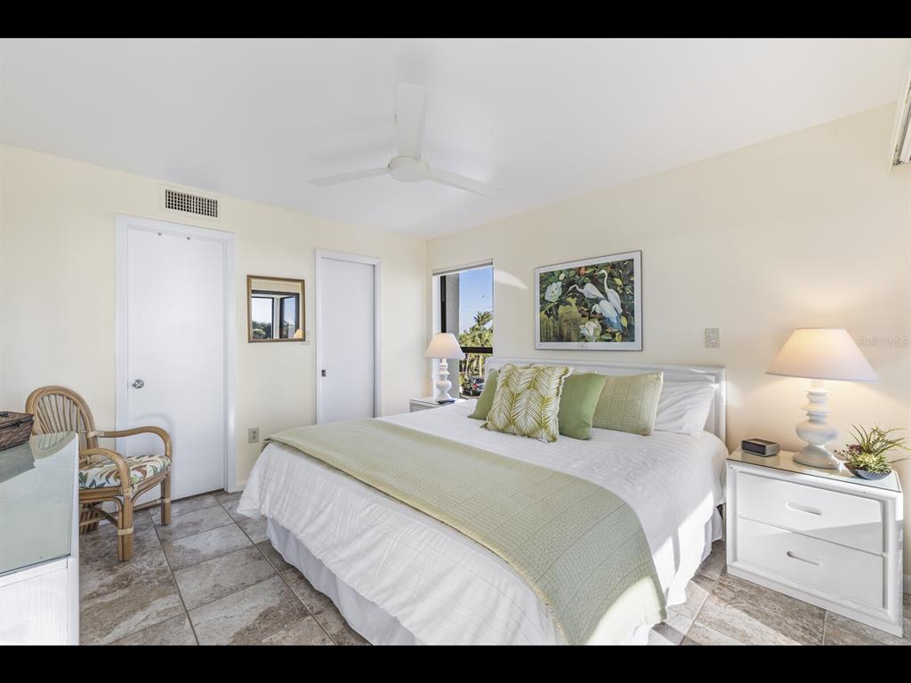 5000 Gasparilla Road, Unit BC201 Boca Grande, FL 33921 - Photo 7 of 25 a bedroom with a bed and a lamp
