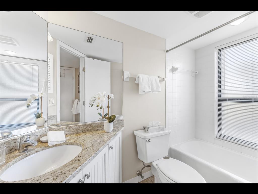 5000 Gasparilla Road, Unit BC201 Boca Grande, FL 33921 - Photo 8 of 25 a bathroom with a granite countertop sink toilet and shower