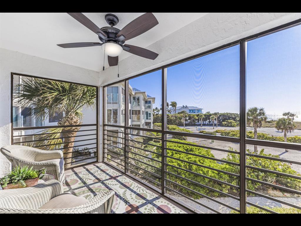 5000 Gasparilla Road, Unit BC201 Boca Grande, FL 33921 - Photo 9 of 25 a view of a balcony with couches and wooden floor