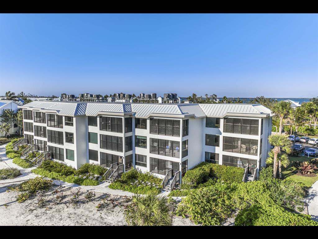 5000 Gasparilla Road, Unit BC201 Boca Grande, FL 33921 - Photo 10 of 25 a view of a large building with a yard and balcony