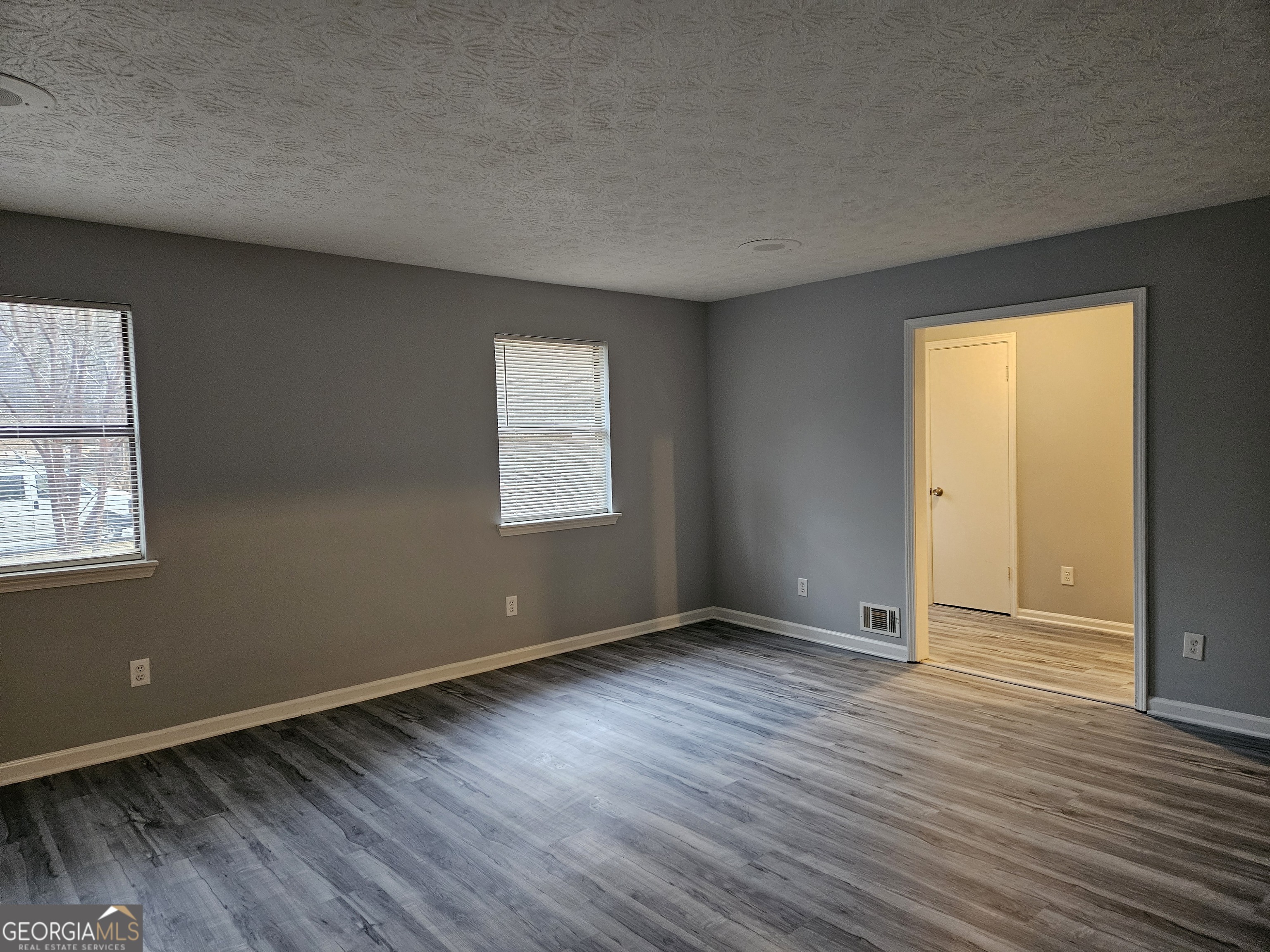 4321 Sebring Walk, Unit 5 Decatur, GA 30034 - Photo 12 of 31 an empty room with wooden floor and windows