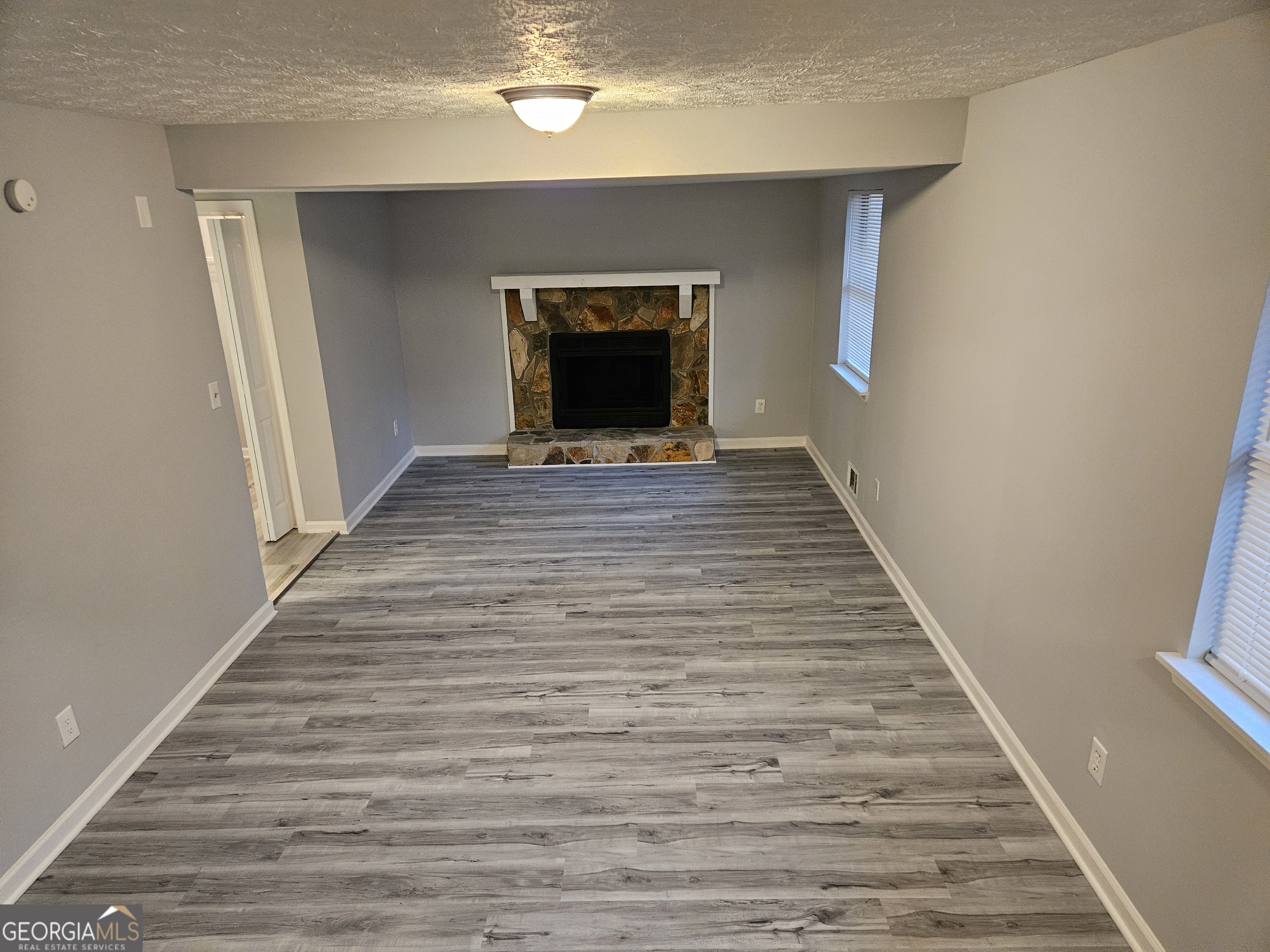 4321 Sebring Walk, Unit 5 Decatur, GA 30034 - Photo 28 of 31 a view of a hallway with wooden floor and a fireplace