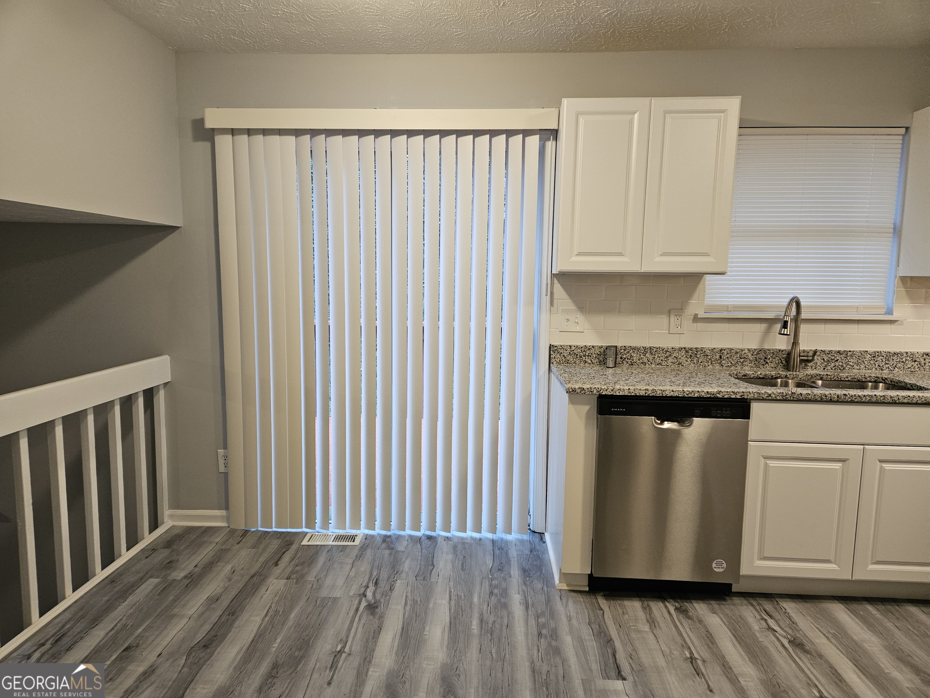 4321 Sebring Walk, Unit 5 Decatur, GA 30034 - Photo 4 of 31 a kitchen with granite countertop white cabinets stainless steel appliances and wooden floor