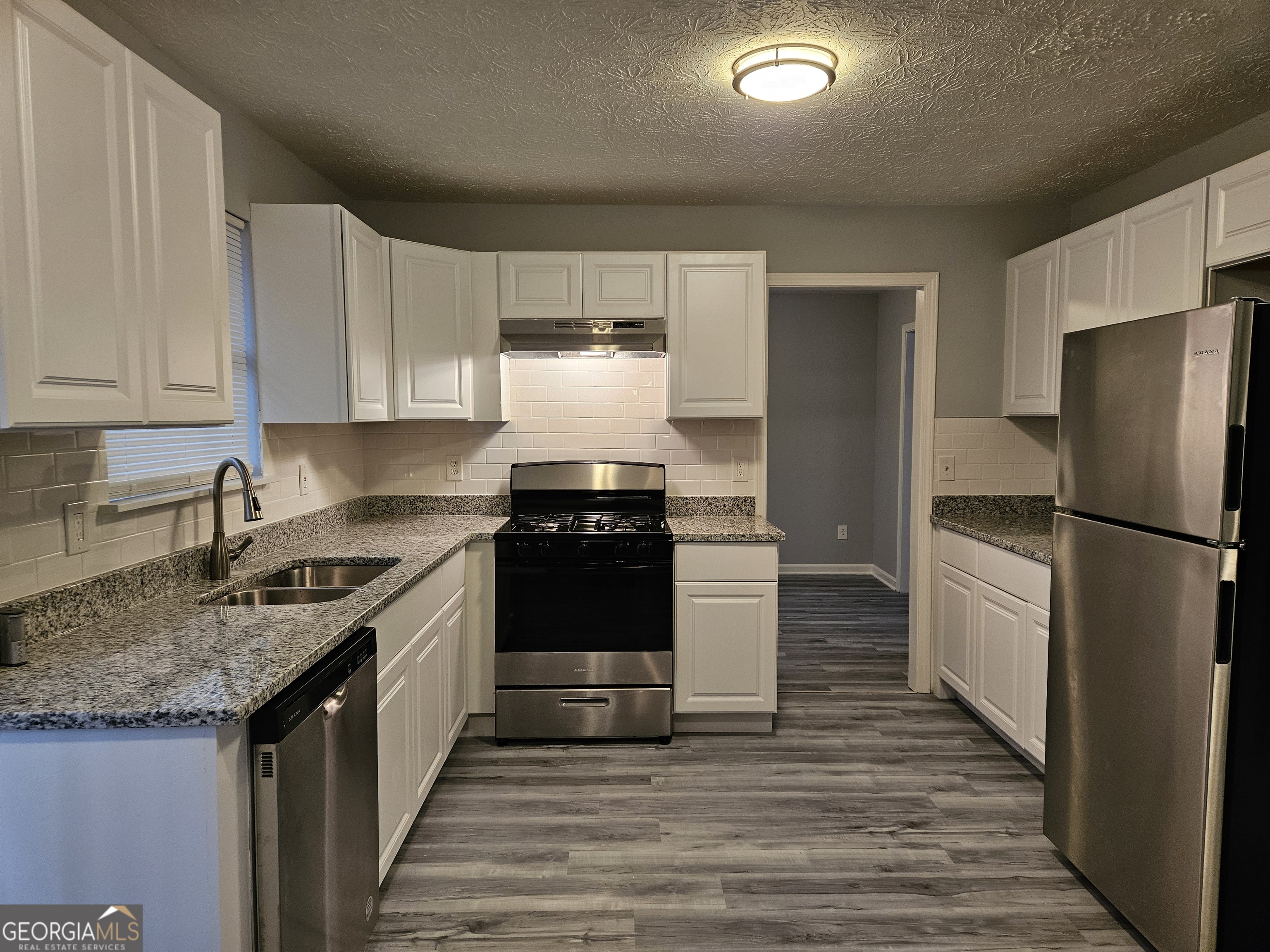 4321 Sebring Walk, Unit 5 Decatur, GA 30034 - Photo 6 of 31 a kitchen with granite countertop a refrigerator stove and oven