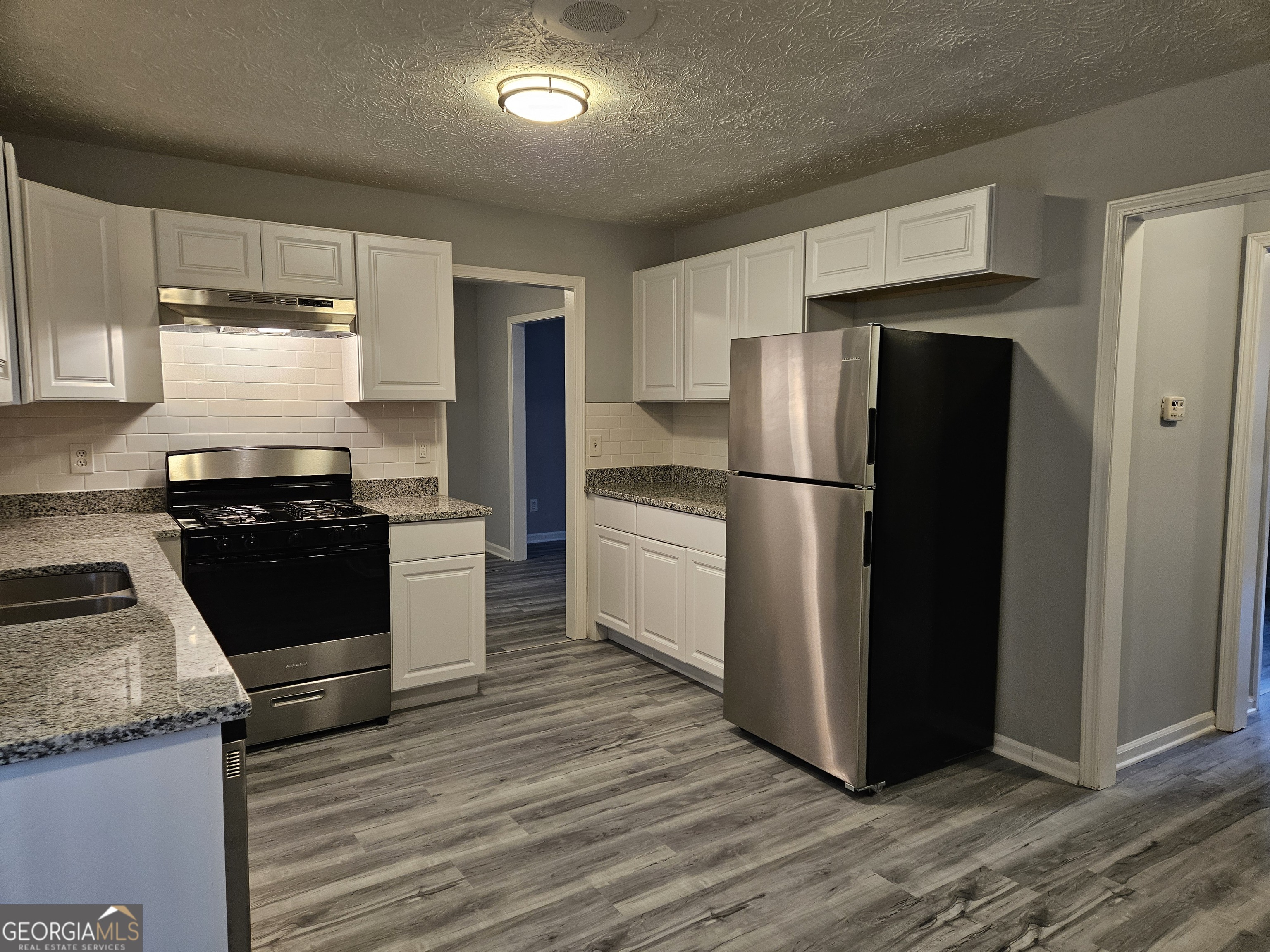 4321 Sebring Walk, Unit 5 Decatur, GA 30034 - Photo 7 of 31 a kitchen with a refrigerator stove and wooden cabinets