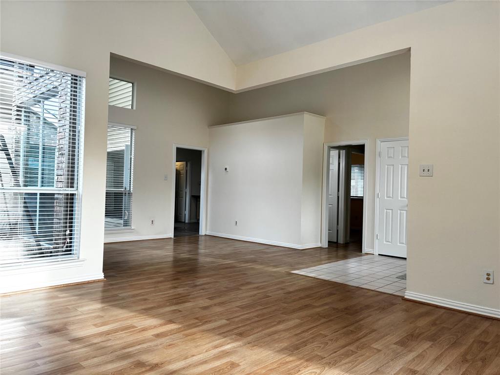 7936 Tournament Road Frisco, TX 75035 - Photo 5 of 28 a view of an empty room with wooden floor and a window