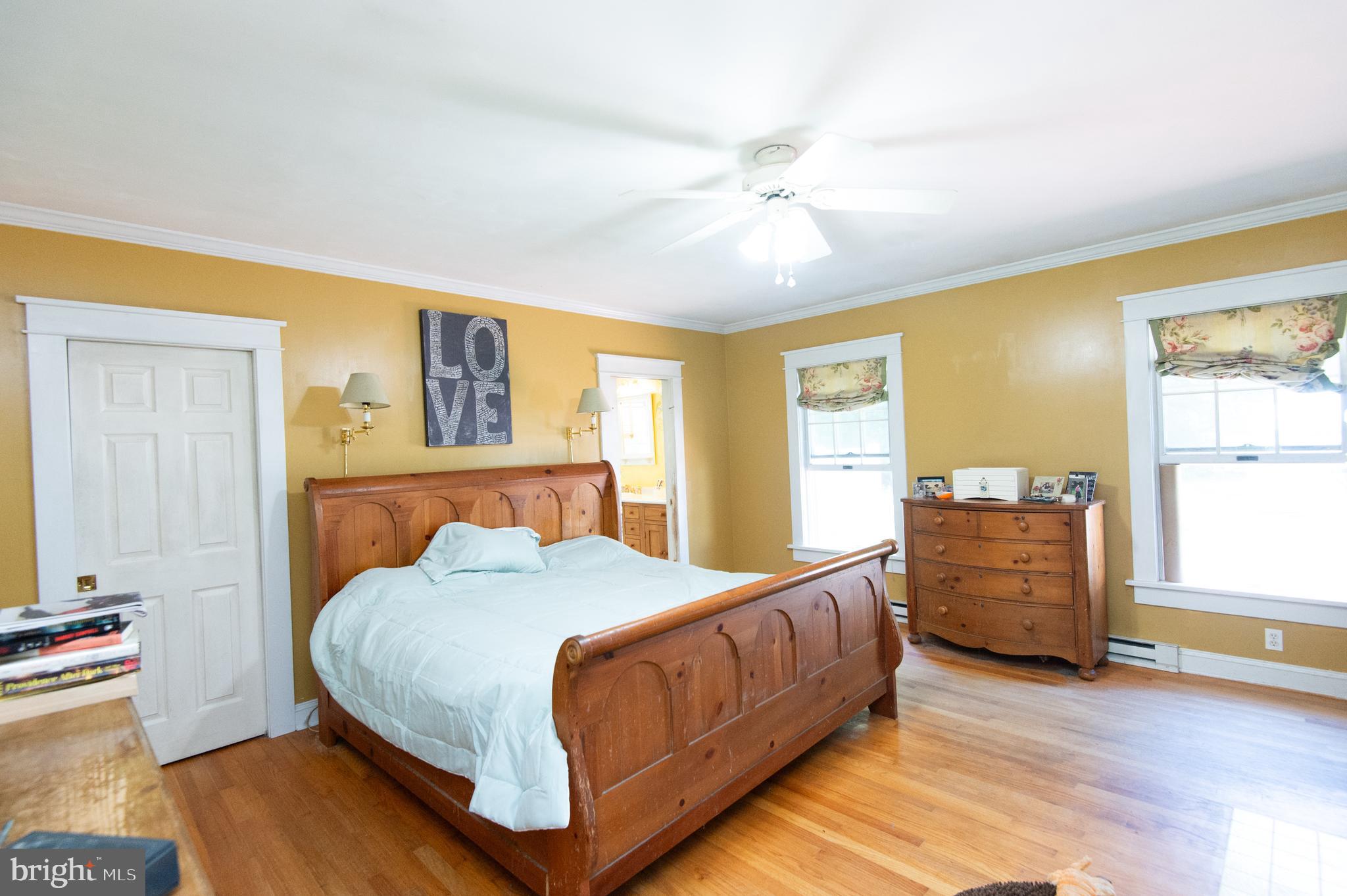 23130 Sparks Road Ridgely, MD 21660 - Photo 35 of 74 a bedroom with a bed and wooden floor