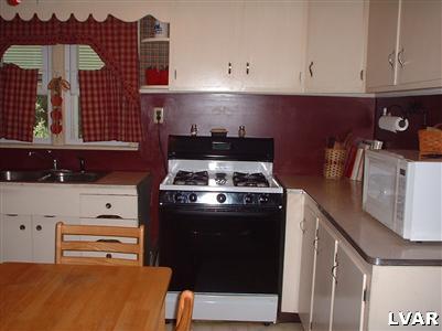 2333 West Best Road Bath, PA 18014 - Photo 5 of 8 a kitchen with stainless steel appliances granite countertop a stove and a refrigerator