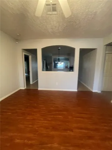 a view of a big room with wooden floor and cabinet