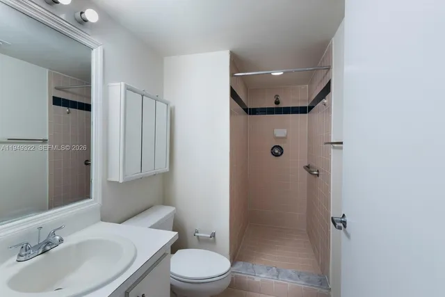 a bathroom with a toilet sink and shower
